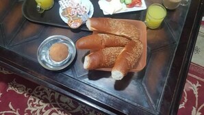 A breakfast tray on a glass coffee table with various food items and drinks. - Downtowninn (Cairo)