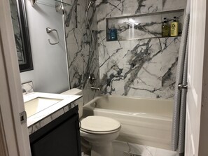 Combined shower/tub, hair dryer, towels, soap