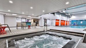 An indoor swimming pool with a hot tub, seating area, and a reception desk. - The Sky's the Limit at Mountain Green 2BD/2BA: Close to Slopes / Discount Tickets (Killington)