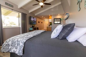 A bedroom with a bed, a ceiling fan, a window, and a view of the outside. - Great rates at Kihei Bay Surf G259 Comfortable Studio Space! (Kihei)