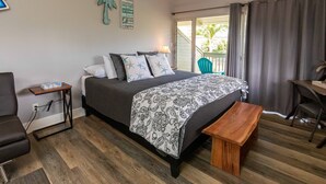 A bedroom with a bed, bedside table, bench, and a desk with a chair. - Great rates at Kihei Bay Surf G259 Comfortable Studio Space! (Kihei)