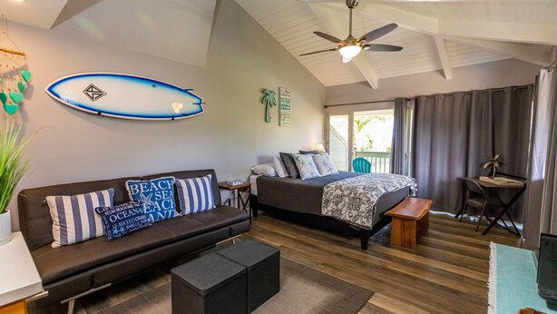 A modern bedroom with a bed, a sofa, a desk, and a ceiling fan. - Great rates at Kihei Bay Surf G259 Comfortable Studio Space! (Kihei)