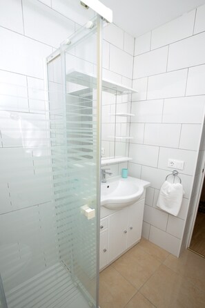Shower, hair dryer, towels, soap