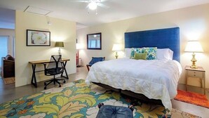 A bedroom with a large bed, a desk, a chair, and a ceiling fan. - Solar powered, central, private, secure guest house! (Tucson)