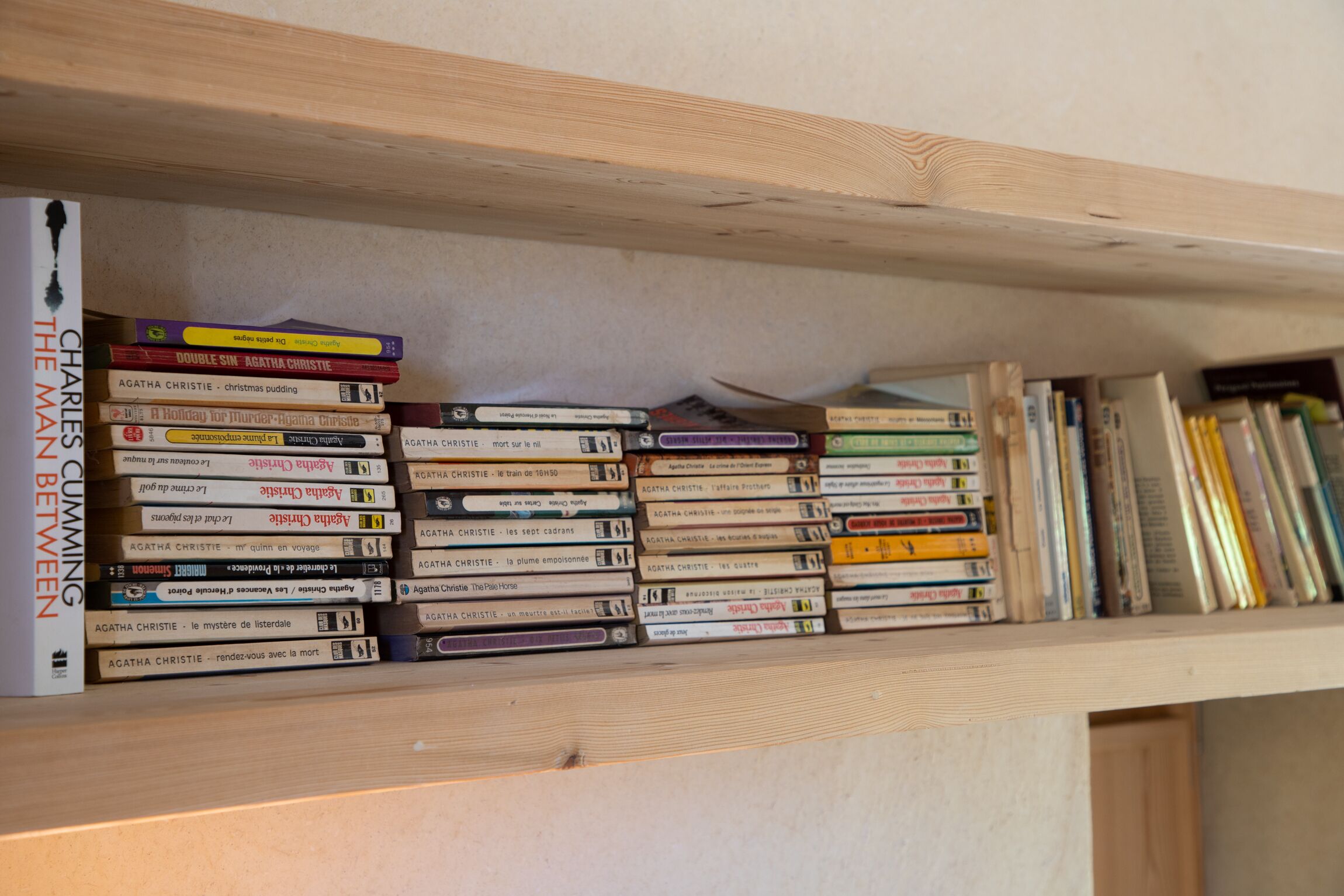 A bookshelf filled with books, including titles by Agatha Christie.
