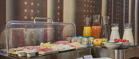 A buffet with various food items and beverages.