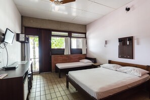 A hotel room with a bed, a desk, a chair, a TV, and a window with curtains. - Mira Maré Praia Hotel (Guarujá)