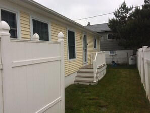 Standalone home with a front porch and white picket fence.
