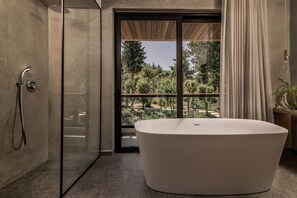 Bathtub, hair dryer, bathrobes, towels