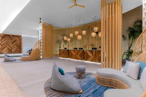 A modern lounge area with a high ceiling, wooden slats, and hanging spherical lights. - Hilton Tulum Riviera Maya All-Inclusive Resort (Tulum)