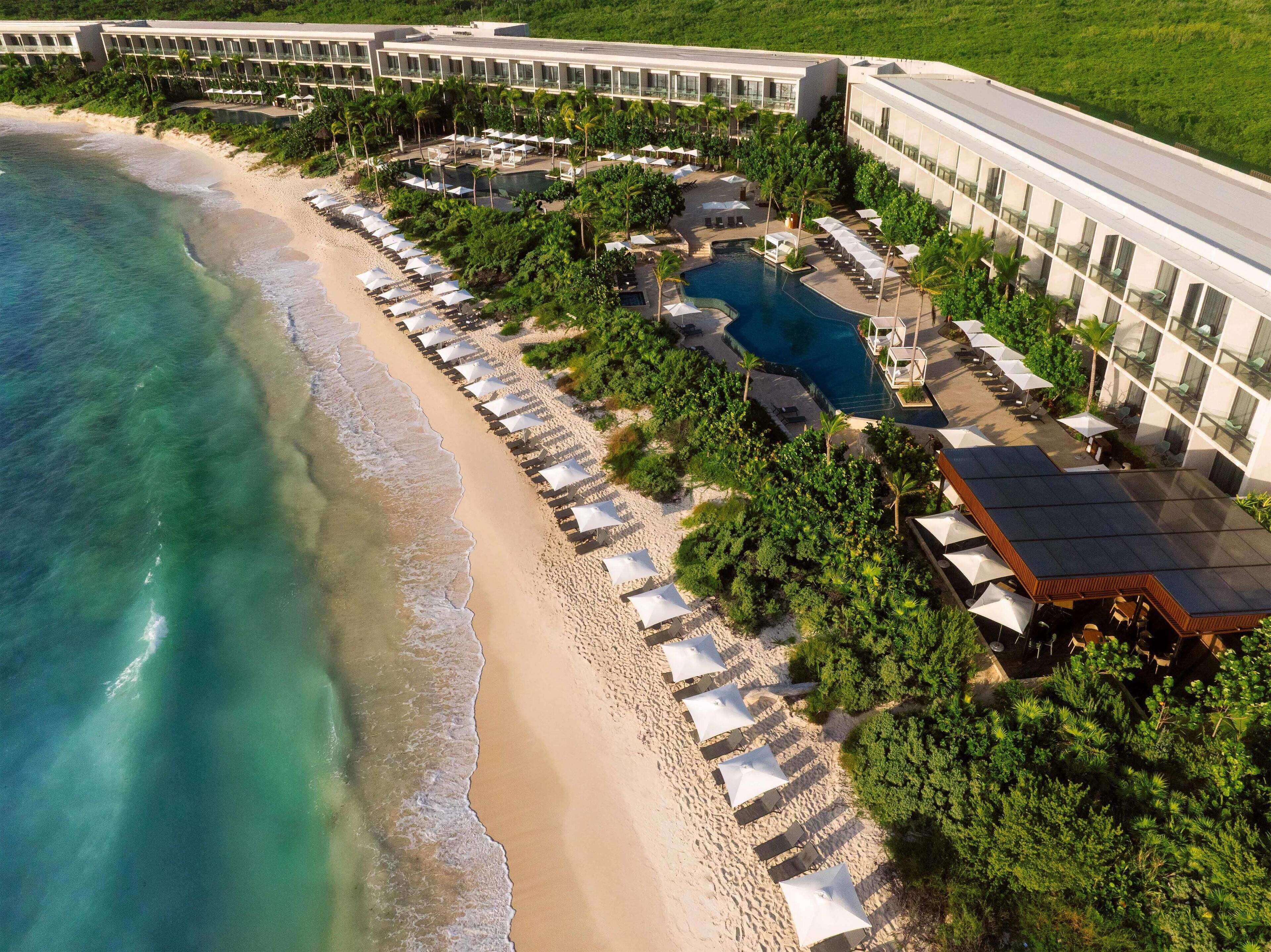On the beach, white sand, sun loungers, beach umbrellas