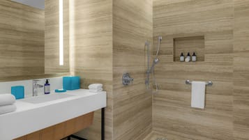 Une salle de bain moderne avec un lavabo blanc, des distributeurs de savon bleus, une cabine de douche en verre et un porte-serviettes.