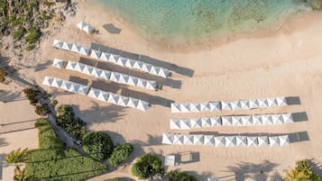 On the beach, white sand, sun loungers, beach umbrellas
