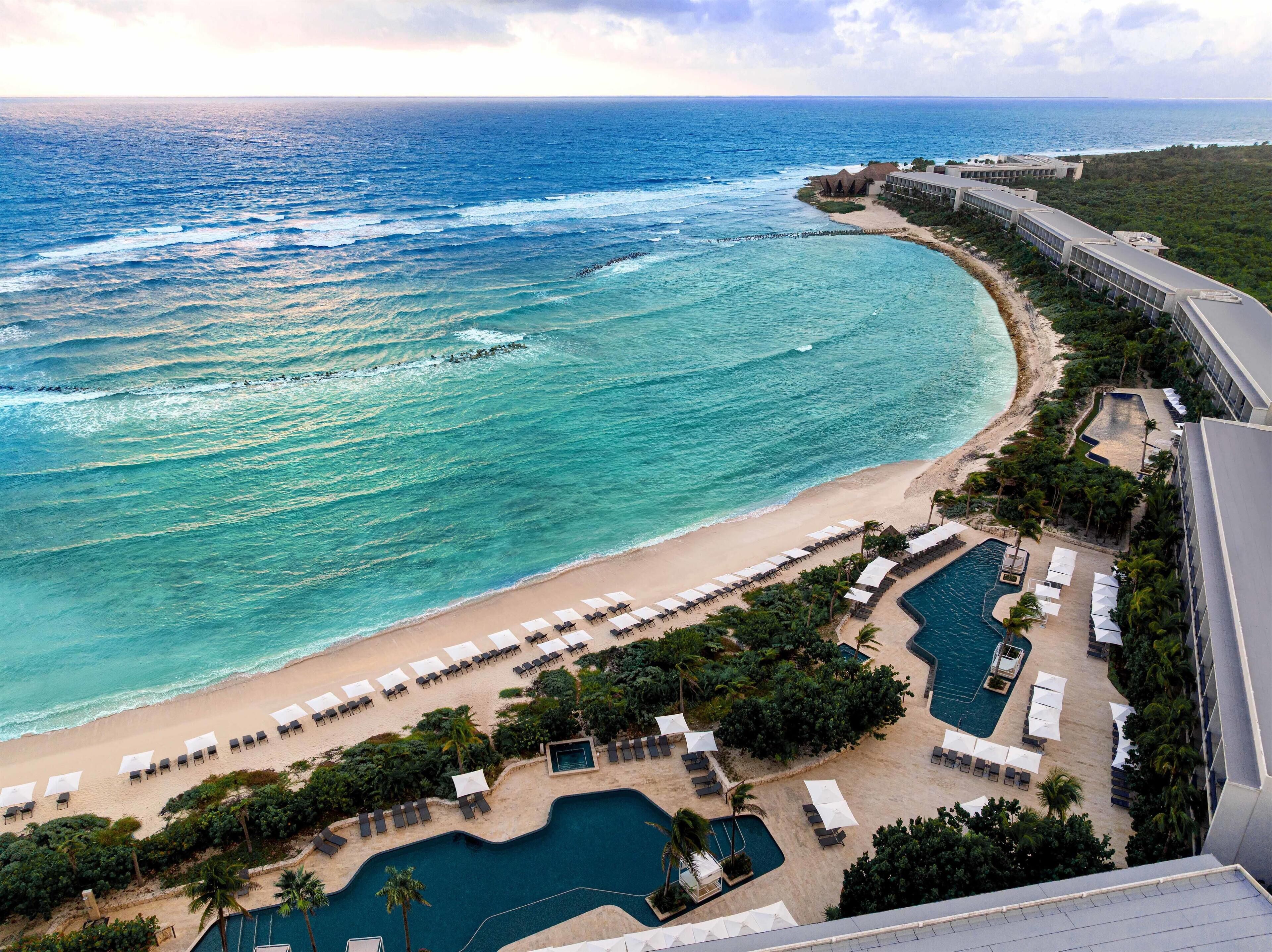 A resort with a beach, a pool area, and ocean views.