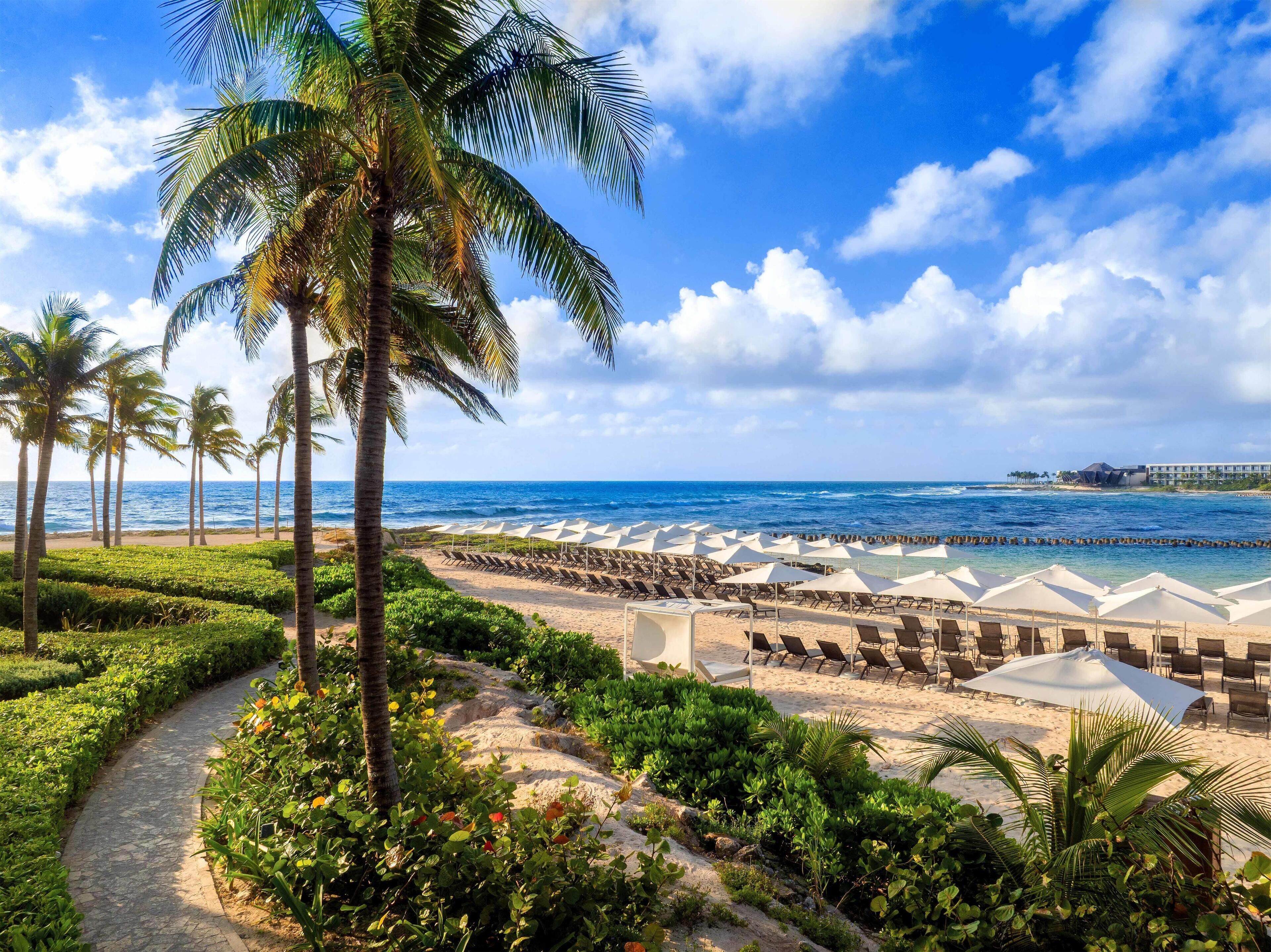 On the beach, white sand, sun-loungers, beach umbrellas