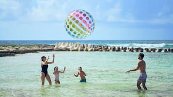 On the beach, white sand, sun-loungers, beach umbrellas