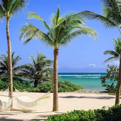 On the beach, white sand, sun loungers, beach umbrellas