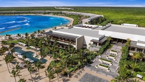 An aerial view of a resort with a large pool, multiple buildings, and a beach area. - Hilton Tulum Riviera Maya All-Inclusive Resort (Tulum)