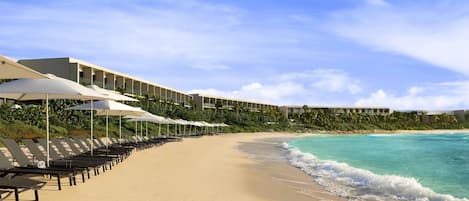 On the beach, white sand, sun loungers, beach umbrellas