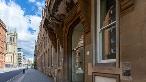 A historic building with large windows and a stone facade. - Ingram Apartments (Glasgow)