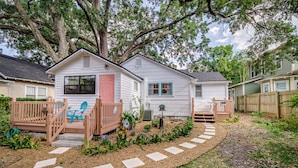 A single-story house with a front porch, a small deck, and a garden with stepping stones. - The Funky Swan Shack by Lake Morton & Downtown (Lakeland)