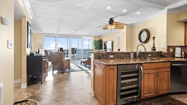 A spacious kitchen with a large island, granite countertops, and modern appliances. - Crystal Sands Tower Unit 703 - Beachfront (Sarasota)