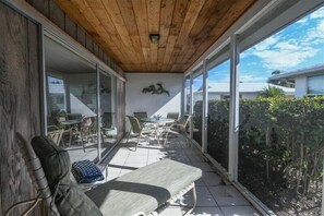 Enjoy dining and socializing in this outdoor space with a glass-enclosed view of the surrounding landscape.
