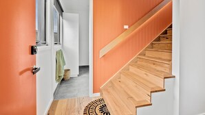 A staircase with wooden steps and a handrail, leading to a room with a white door and a window with curtains. - Apartment Studio 6: In The Heart of Torquay (Torquay)