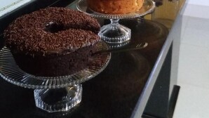 A buffet with various desserts including cakes and a watermelon dish.