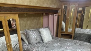A bedroom with a bed, a wardrobe, and a mirror. - North Georgia Mountain Getaway (Cleveland)