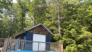 A wooden cabin with a dock, surrounded by dense forest. - Clear water and breath taking view! (Trent Lakes)