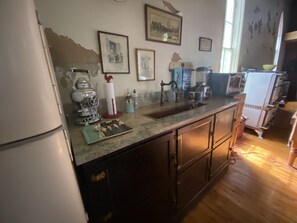 Kitchen area with a window, refrigerator, and various appliances.