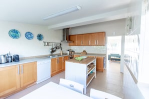 A modern kitchen with wooden cabinets, a white countertop, and a built-in oven.