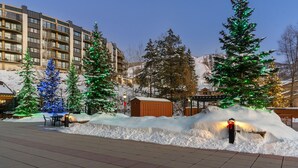 A hotel with multiple floors, outdoor seating, and snow-covered surroundings. - Walk to the ski slopes, restaurants & shops.  Location is everything! (Steamboat Springs)