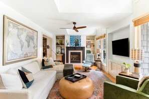 Relax in a comfortable living space with a fireplace, flat-screen TV, and a variety of seating options.