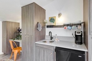 Enjoy cooking in this kitchen with stainless steel sink, coffee maker, and ample counter space.