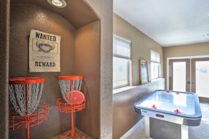 Experience a playful atmosphere in this room, featuring a vintage wanted poster and a foosball table for entertainment.
