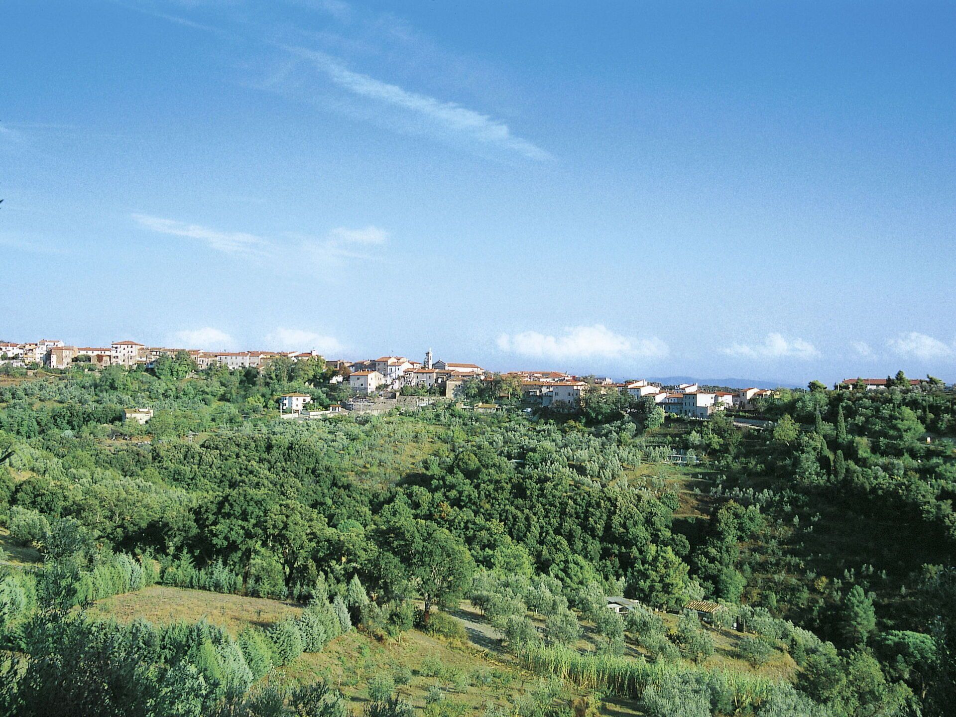 A hillside town with buildings scattered across the landscape.