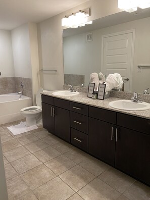 Combined shower/bathtub, hair dryer, towels, toilet paper