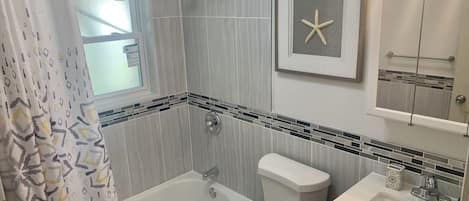 Bathtub, hair dryer, towels, soap