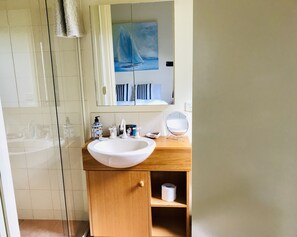 Bathroom features a large sink, vanity, and mirror, with a towel hanging nearby.