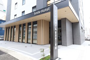 Exterior del Hotel Smile, con fachada moderna, amplias ventanas y una entrada destacada.