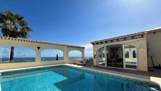 A pool area with a clear view of the sea, a covered seating area, and a tiled pool. - T-0121, Canarios, Fantastic villa with panoramic sea views (Denia)