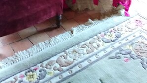 A room with a stone wall, a wooden cabinet, a small table, and two chairs covered in pink fabric. - RENAISSANCE cottage (Courchamps)