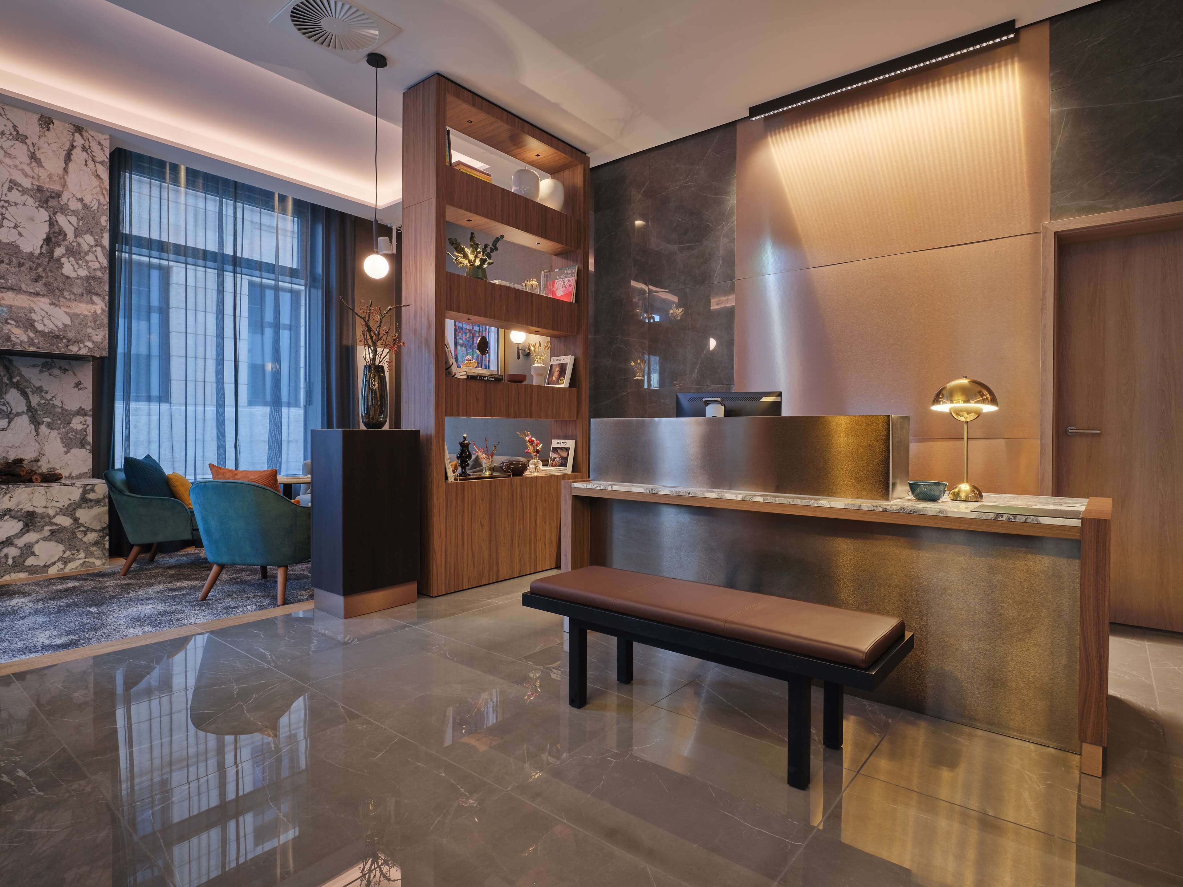 A modern interior with a marble floor, wooden furniture, and a bench.