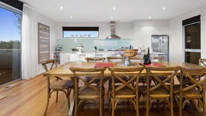 A modern kitchen with a dining area.