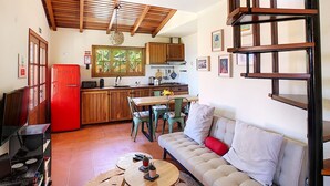 A compact living space with a kitchenette, a dining area, and a sofa. - Pôr do Sol by LovelyStay (Arco Da Calheta)