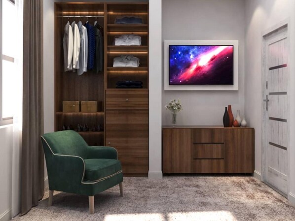 A modern room with a green armchair, a wooden wardrobe, a vanity with a mirror, and a large TV displaying a space scene.