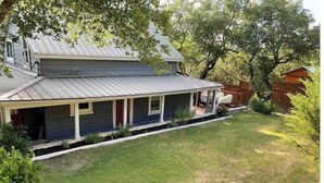 A two-story house with a covered porch and a fenced yard. - Hop/Skip/Jump to Canyon Lake - 3 BR, 2 Bath (Canyon Lake)