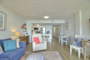 A living room with a sofa, armchairs, a coffee table, and a dining area with chairs and a table. - Gorgeous Oceanfront 1 Bedroom with Stunning Views of the Atlantic at Verandas North Myrtle Beach (North Myrtle Beach)